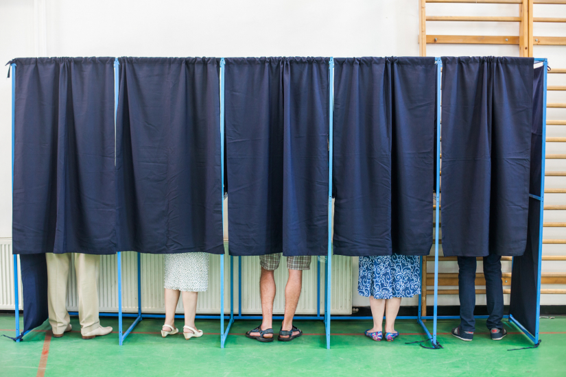 People voting in booths